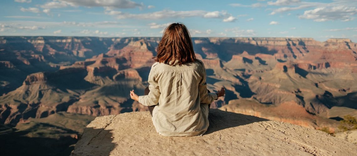 Woman sitting on a hill meditating